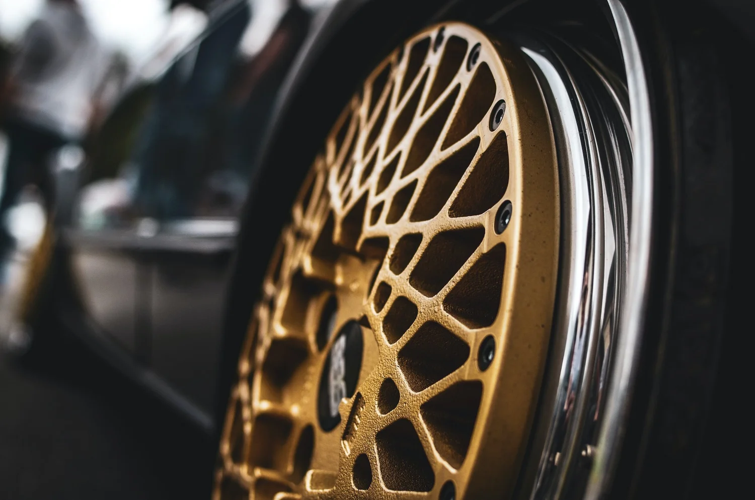 Gold aftermarket wheel and brake detail on a customer car
